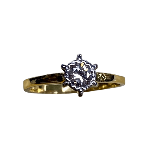 Ladies 18ct Yellow & White Gold Single Stone Diamond Ring. Round Brilliant Cut Diamond Illusion Grain Set With Tapered Gallery With Pointed Swept Up Shoulders. TDW 0.20ct. Size L/6, With Valuation Certificate (NG 142944)