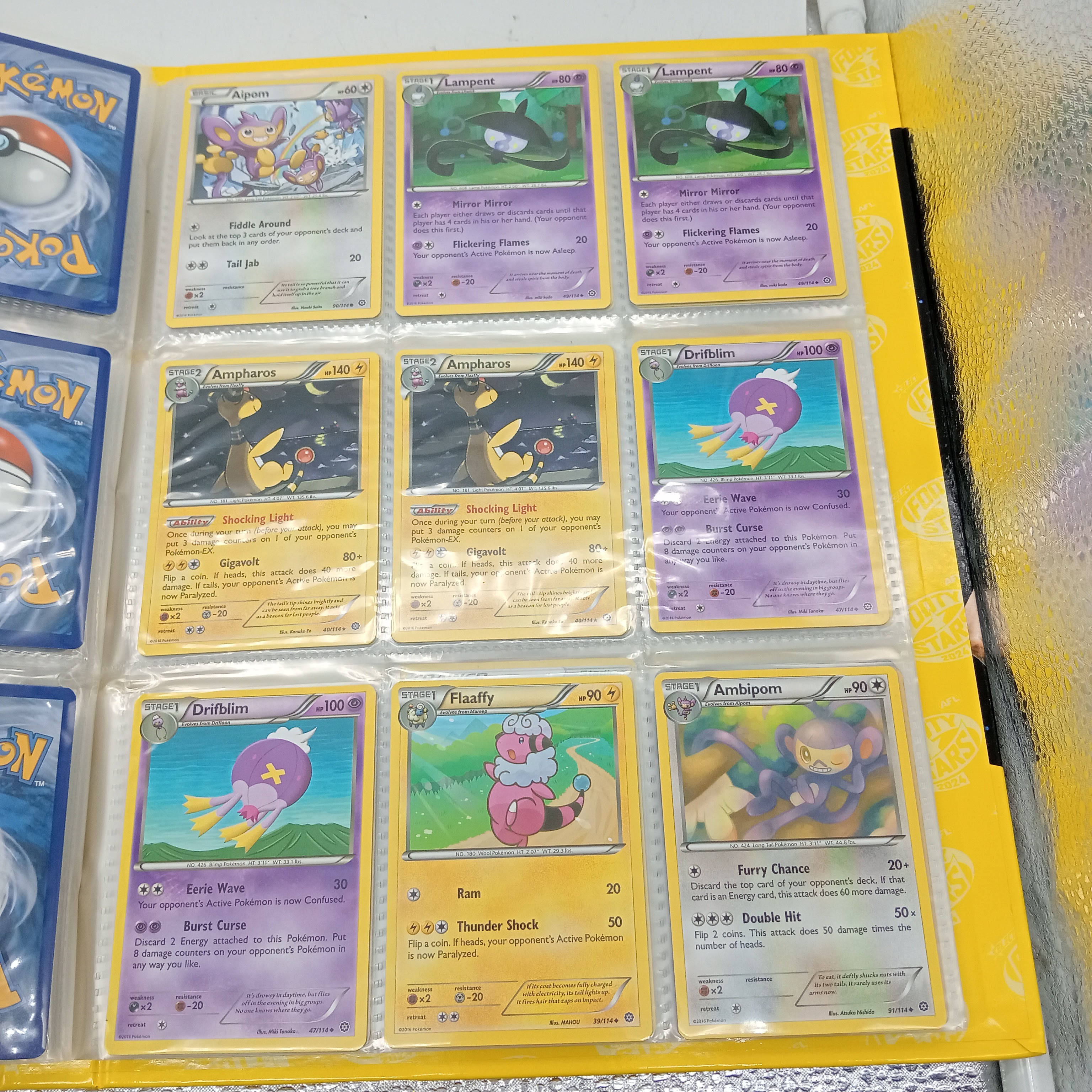 Estimated 170 Assorted Pokemon Cards In AFL Album Includes: Holo, Reverse Holo, Common, Trainer Cards (WR 1343495)