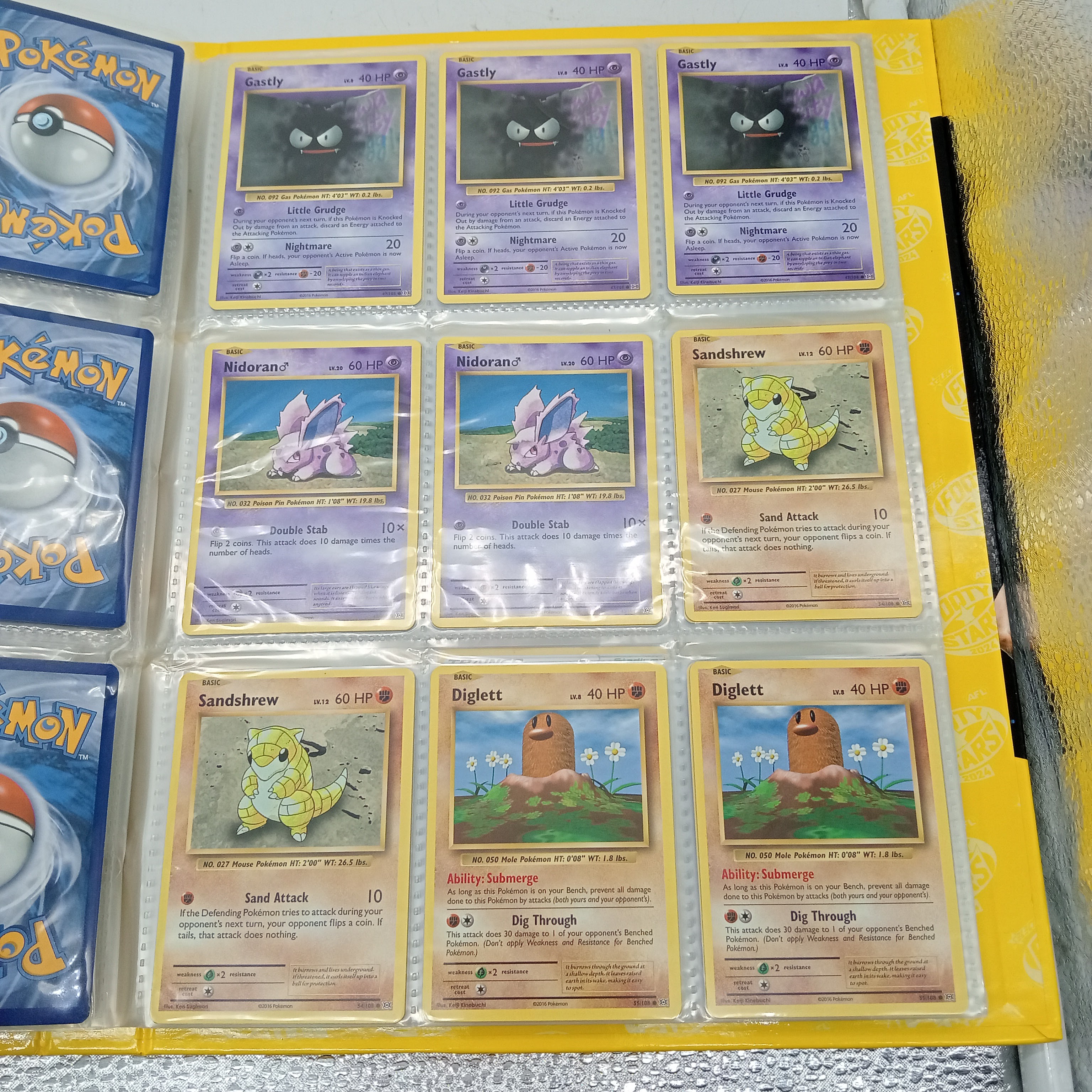 Estimated 170 Assorted Pokemon Cards In AFL Album Includes: Holo, Reverse Holo, Common, Trainer Cards (WR 1343495)