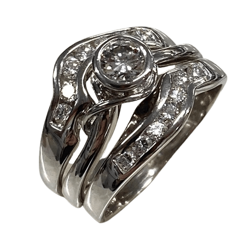 Ladies 18ct White Gold 3 Ring Set. Rub Over Set 0.30ct Round Brilliant Cut Diamond, With 7 Round Brilliant Cut Channel Set In Fitted Bands Each Side. TDW 0.72ct. Size O  With Valuation Certificate.