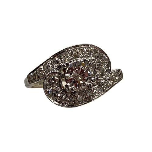 Ladies 14ct White Gold 19 Diamond Ring. Round Brilliant Cut 4 Claw Set 0.35ct Diamond. With 18 Round Brilliant Cut Diamonds Grain Set Stones Set in Cross Over Shoulders. TDW 0.78ct. Size L/6 . With Valuation Certificate – (NG 145637)