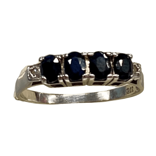 Ladies 9ct White Gold 6 Stone Sapphire & Diamond Ring. 4 Oval Sapphires, 4 Claw Set. With 2 Square Grain Set Diamonds In Swept Up Shoulders. TDW 1.15ct. Size P/8 . With Valuation Certificate – (NG 73254)