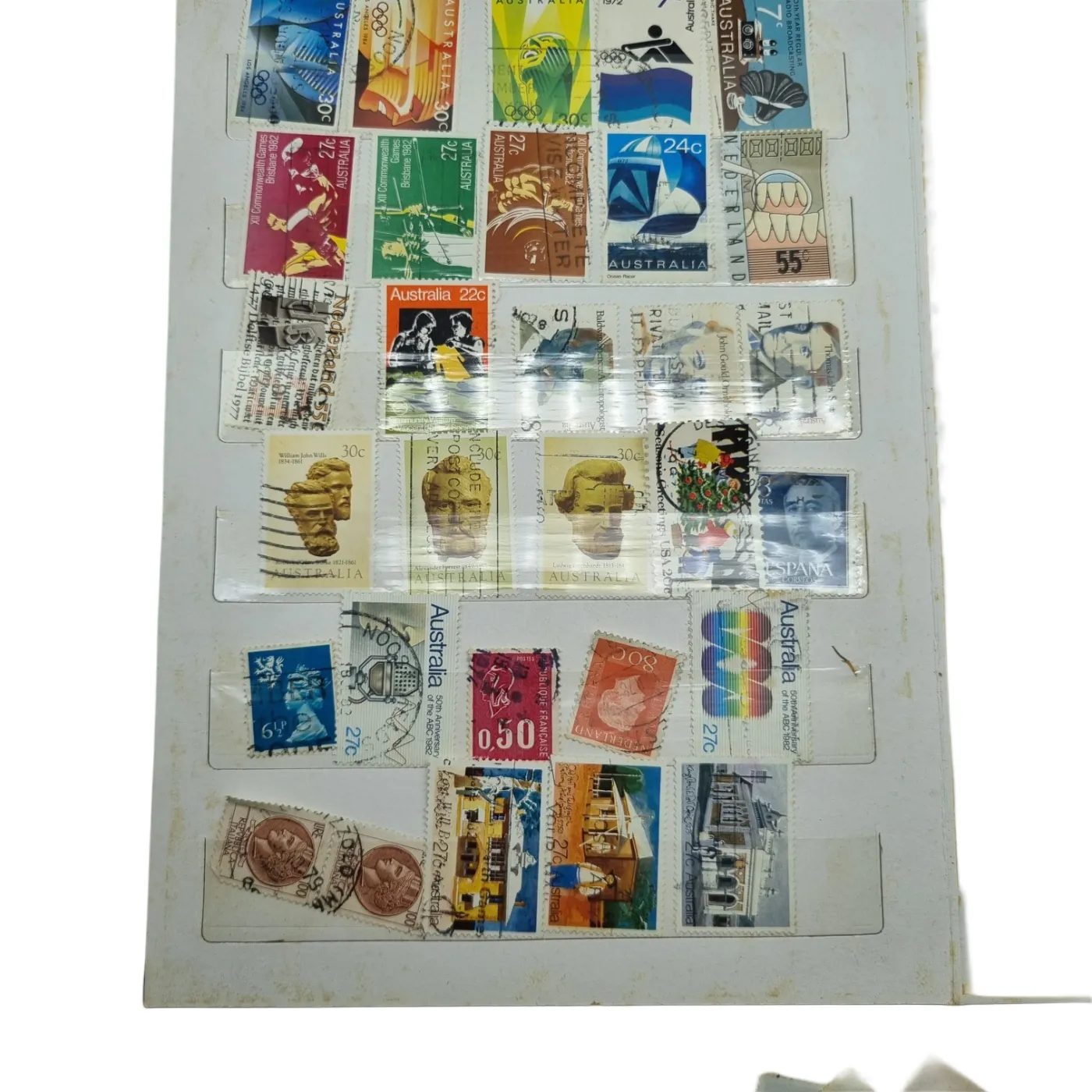 Assorted Global Stamps In Blue Stamp Book (Including: Indonesia, Australia, USA, Nederland)