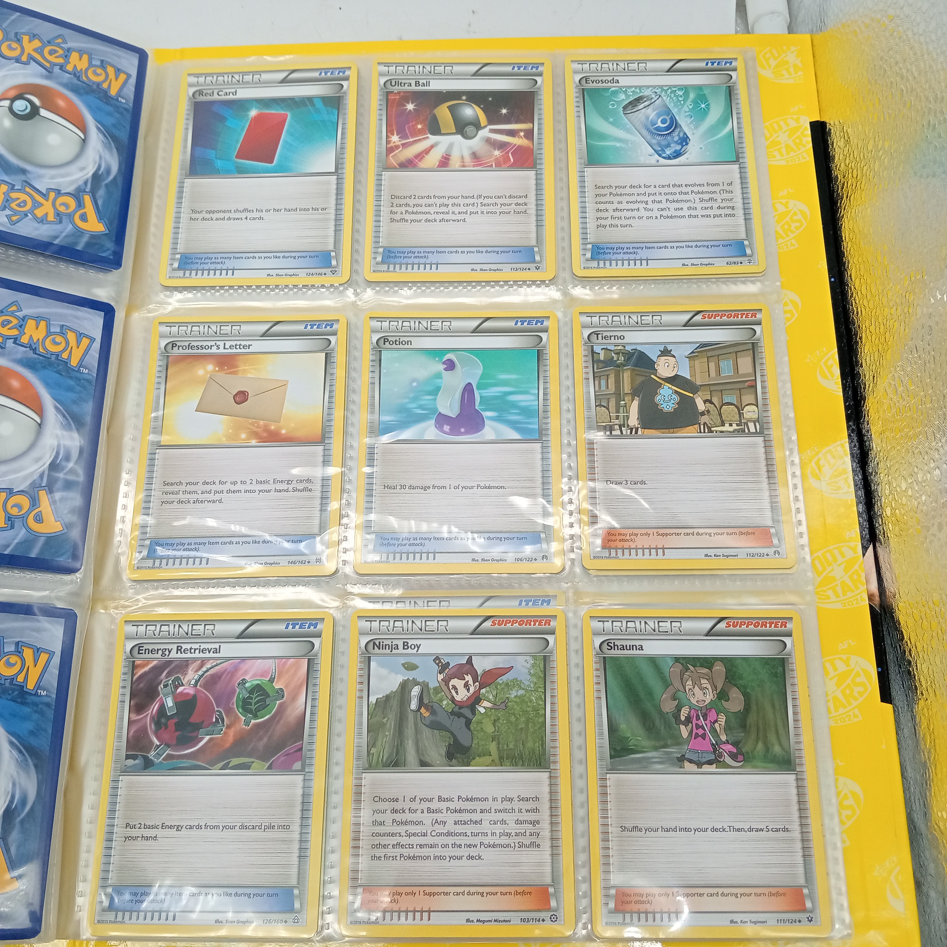 Estimated 170 Assorted Pokemon Cards In AFL Album Includes: Holo, Reverse Holo, Common, Trainer Cards (WR 1343495)