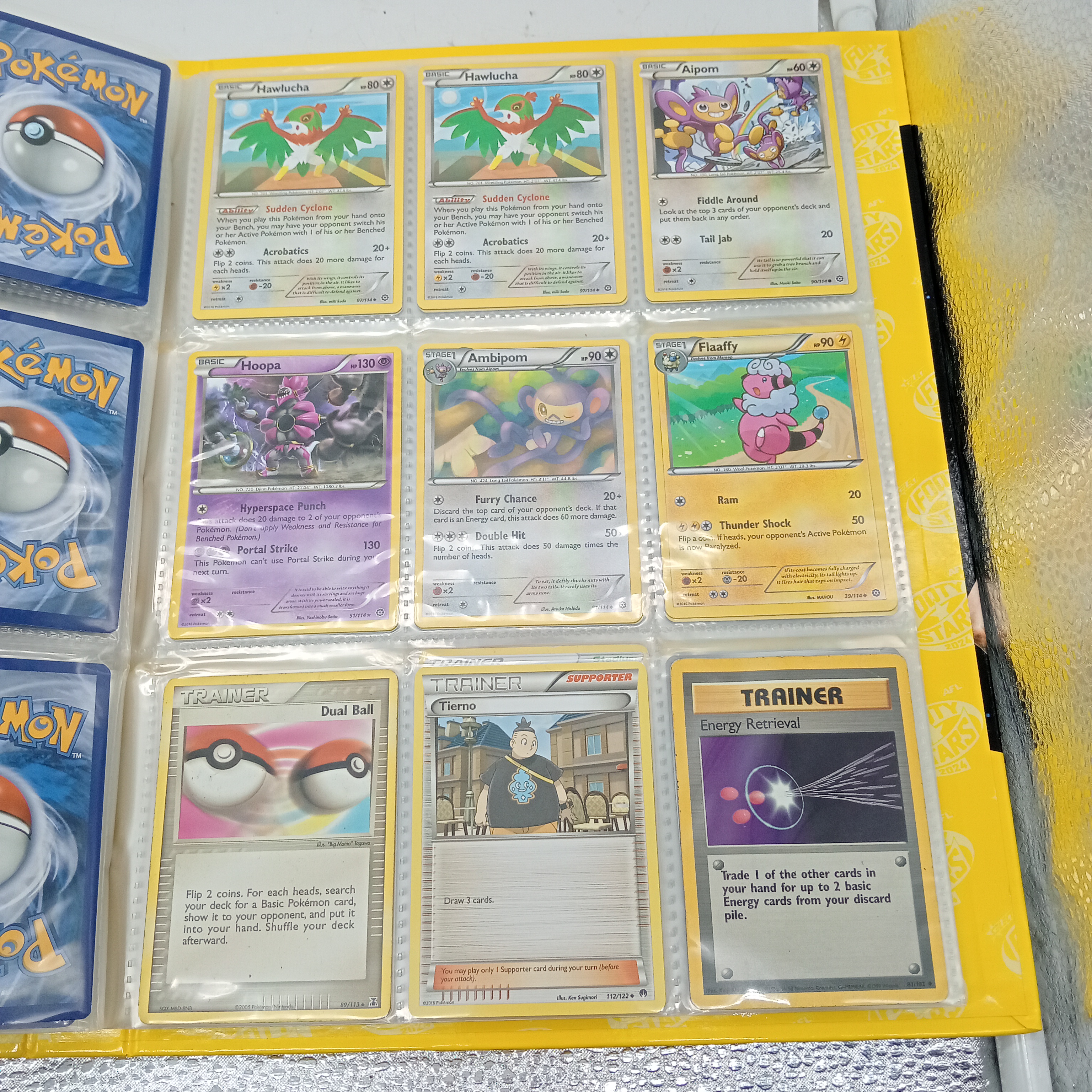 Estimated 170 Assorted Pokemon Cards In AFL Album Includes: Holo, Reverse Holo, Common, Trainer Cards (WR 1343495)