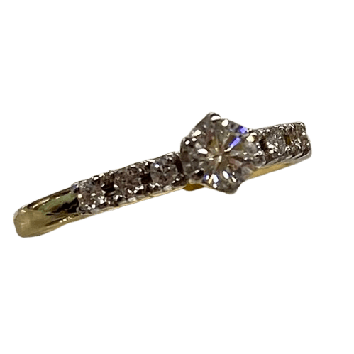 Ladies 18ct Yellow & White Gold Diamond Ring. Single Round 0.20ct Brilliant Cut White Gold Claw Set Diamond, With 6 Round Brilliant Cut White Gold Claw Set Diamonds. TDW 0.29ct. Size L&1/2 . With Valuation Certificate.