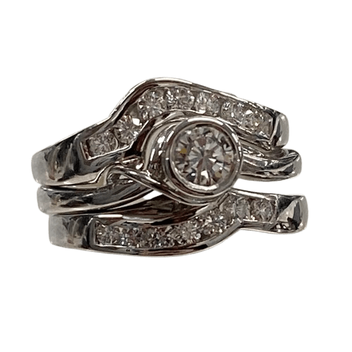 Ladies 18ct White Gold 3 Ring Set. Rub Over Set 0.30ct Round Brilliant Cut Diamond, With 7 Round Brilliant Cut Channel Set In Fitted Bands Each Side. TDW 0.72ct. Size O  With Valuation Certificate.