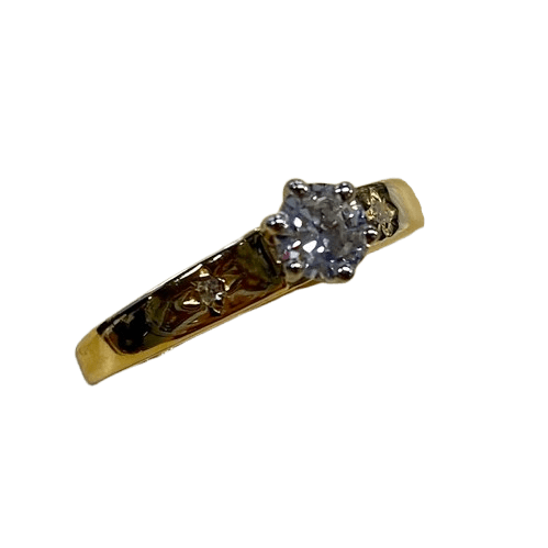 Ladies 18ct Yellow & White Gold 3 Stone Diamond Ring. Round Brilliant Cut 6 Claw Tapered Collet White Gold On A Yellow Gold Under Rail Diamond, With 2 Single Cut Diamonds Star Grain Set In Flat Top Swept Up Shoulders. TDW 0.32ct. Size N/7, With Valuation Certificate (NG 132482)