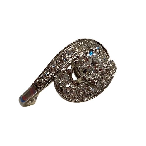 Ladies 14ct White Gold 19 Diamond Ring. Round Brilliant Cut 4 Claw Set 0.35ct Diamond. With 18 Round Brilliant Cut Diamonds Grain Set Stones Set in Cross Over Shoulders. TDW 0.78ct. Size L/6 . With Valuation Certificate – (NG 145637)