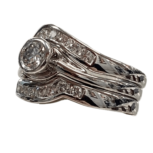 Ladies 18ct White Gold 3 Ring Set. Rub Over Set 0.30ct Round Brilliant Cut Diamond, With 7 Round Brilliant Cut Channel Set In Fitted Bands Each Side. TDW 0.72ct. Size O  With Valuation Certificate.