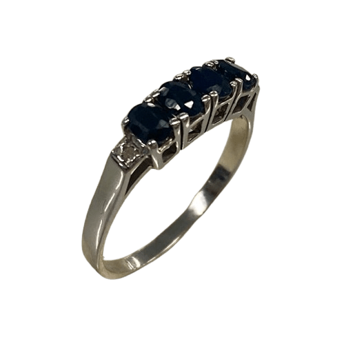 Ladies 9ct White Gold 6 Stone Sapphire & Diamond Ring. 4 Oval Sapphires, 4 Claw Set. With 2 Square Grain Set Diamonds In Swept Up Shoulders. TDW 1.15ct. Size P/8 . With Valuation Certificate – (NG 73254)