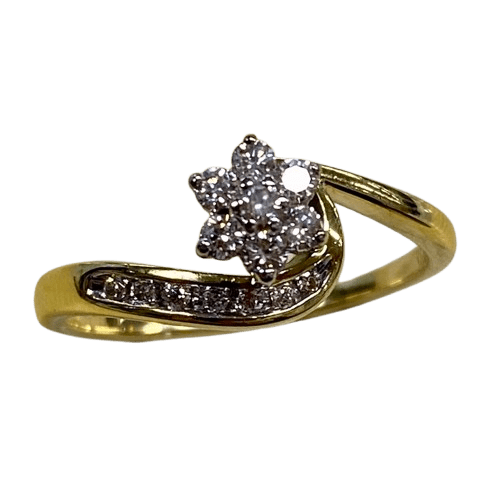 Ladies 18ct White & Yellow Gold 14 Stone Diamond Ring. Round Brilliant Cut White Gold 6 Claw Set Centre Stone Surrounded By 6 Round Brilliant Cut White Gold Claw Set Forming A Cluster. With 7 Brilliant Cut Diamonds Channel Set In Wrap Around Shoulder. TDW 0.26ct. Size R/9, With Valuation Certificate – (NG 147229)
