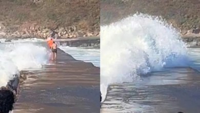 Dramatic moment two people swept away by crashing waves Dramatic moment two people swept away by crashing waves