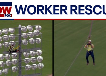 VIDEO: Worker rescued from high up on stadium lights VIDEO: Worker rescued from high up on stadium lights