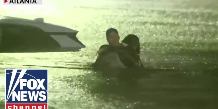 FOX Weather reporter rescues woman from car as floodwaters rise FOX Weather reporter rescues woman from car as floodwaters rise