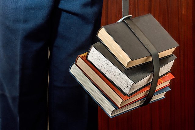 Student holding books. Student holding books.