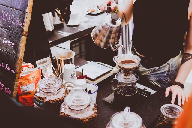 A barista preparing a coffee. A barista preparing a coffee.