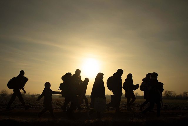 Silhouette of refugees against back drop of a sunrise. Photo by U.S. State Goverment. Silhouette of refugees against back drop of a sunrise. Photo by U.S. State Goverment.