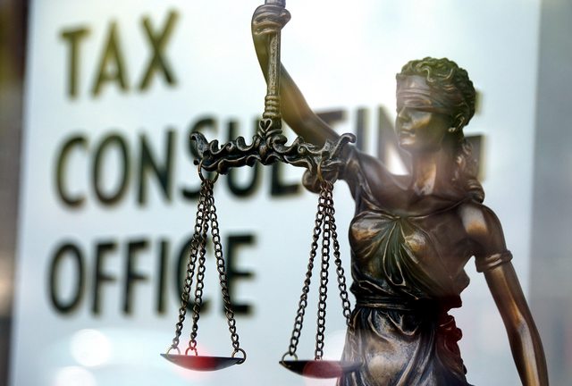 Lady Justice in front of a Tax Consulting Office. Lady Justice in front of a Tax Consulting Office.