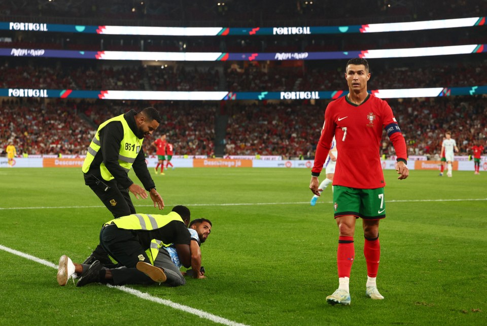 Watch moment pitch invader joins Portugal attack.. and steward has a nightmare Watch moment pitch invader joins Portugal attack.. and steward has a nightmare
