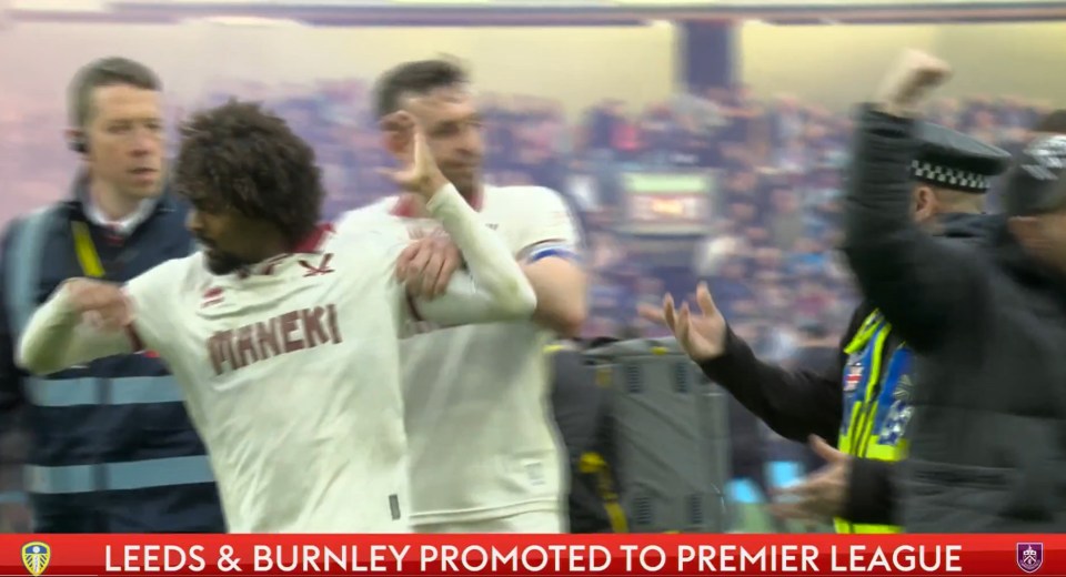 Burnley pitch invasion descends into chaos as rival player is restrained Burnley pitch invasion descends into chaos as rival player is restrained