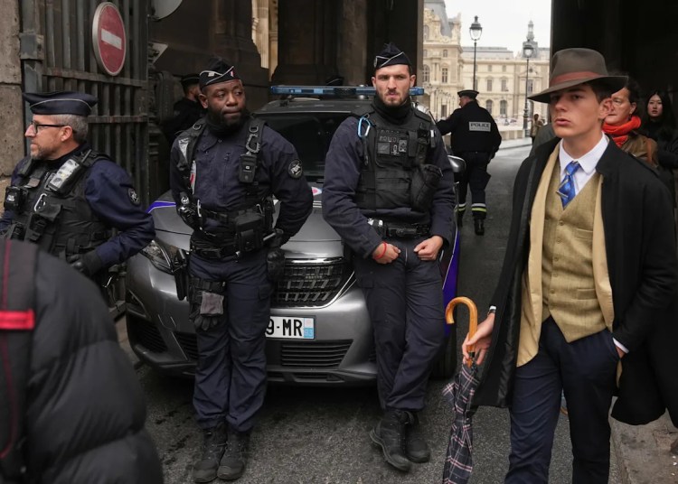 Inspector Clouseau? The thriller man in an AP photograph after the Louvre jewel heist creates a buzz Inspector Clouseau? The thriller man in an AP photograph after the Louvre jewel heist creates a buzz