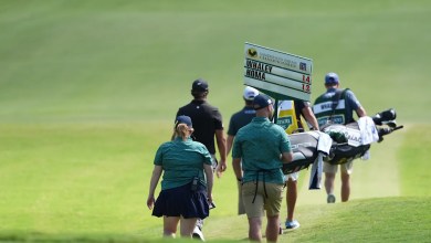 Vince Whaley has an audience with a set of teeth. He hits shot with alligator behind him Vince Whaley has an audience with a set of teeth. He hits shot with alligator behind him