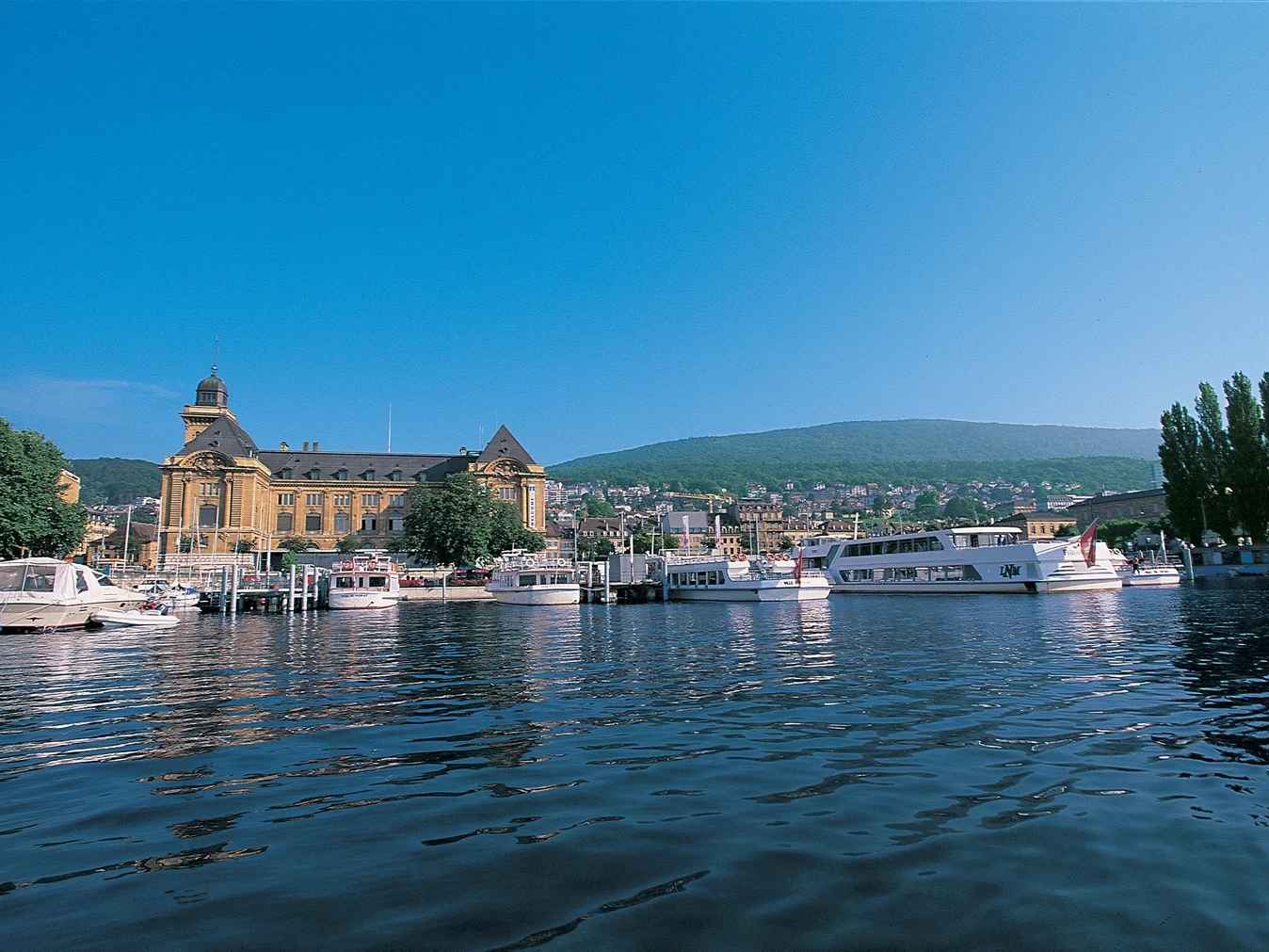 A scenic view of the Neuchâtel Canton showcasing its beautiful landscape and charming architecture. A scenic view of the Neuchâtel Canton showcasing its beautiful landscape and charming architecture.