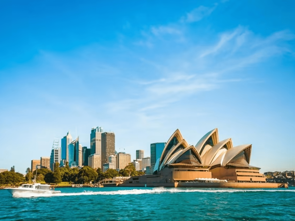 A scenic view of Australia's lush landscapes featuring rolling hills and vibrant greenery under a clear blue sky. A scenic view of Australia's lush landscapes featuring rolling hills and vibrant greenery under a clear blue sky.