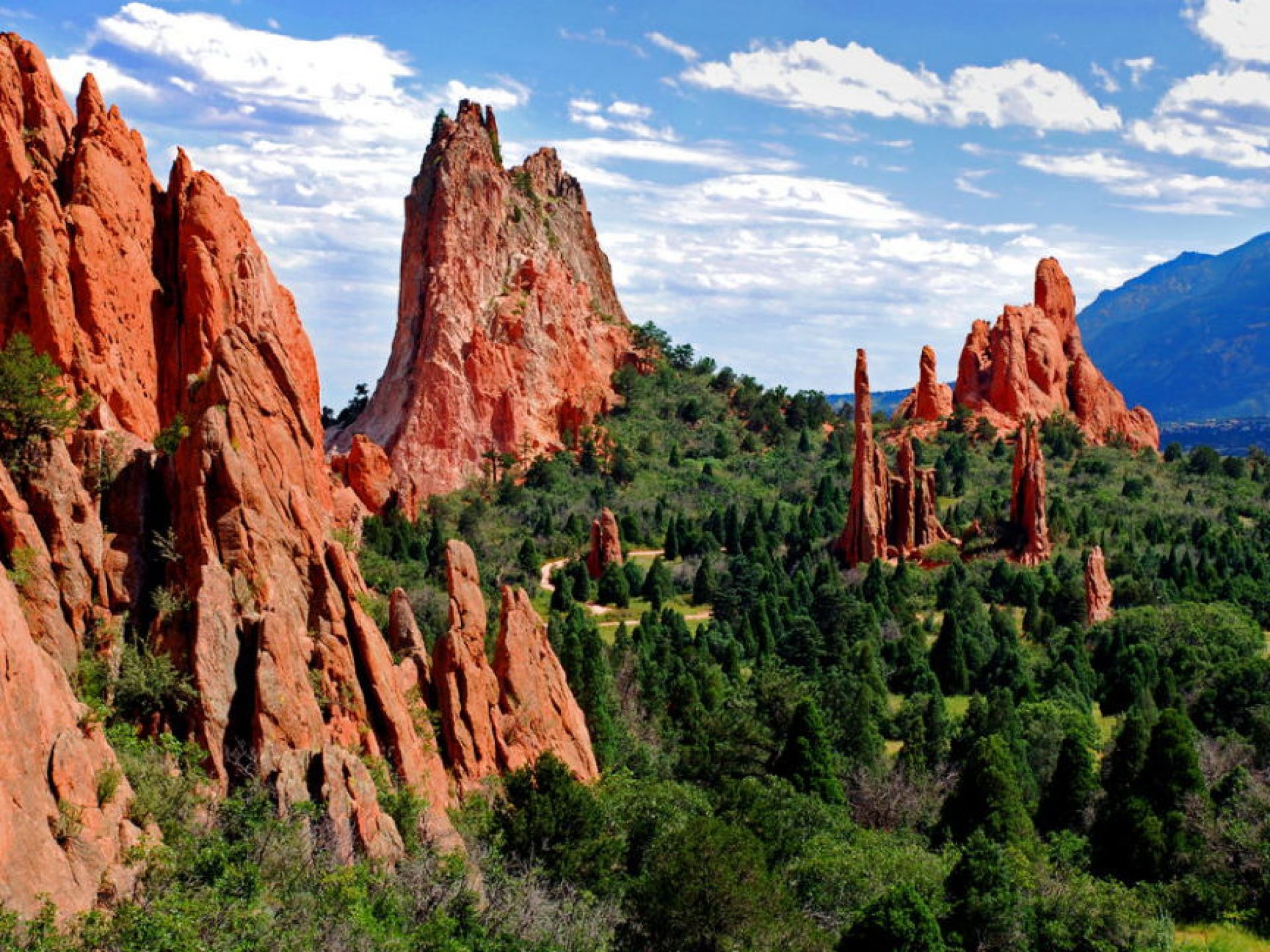 Scenic view of Garden of the Gods in Colorado Springs, showcasing towering red rock formations against a clear blue sky. Scenic view of Garden of the Gods in Colorado Springs, showcasing towering red rock formations against a clear blue sky.