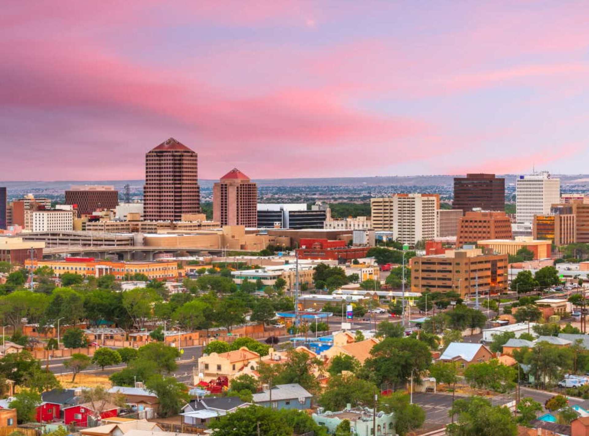 City skyline view of Albuquerque showcasing modern architecture against a clear blue sky. City skyline view of Albuquerque showcasing modern architecture against a clear blue sky.
