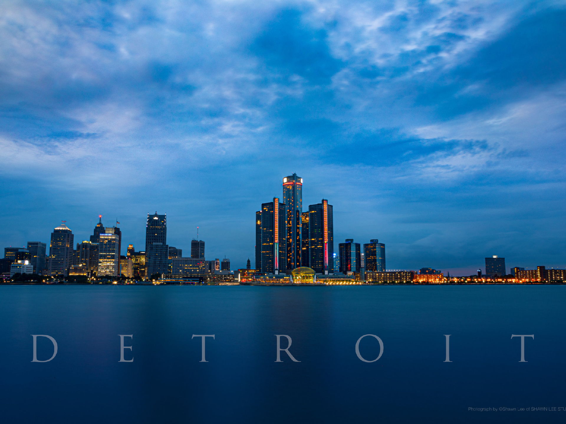 A stunning view of the Detroit skyline showcasing the city's iconic buildings against a clear blue sky. A stunning view of the Detroit skyline showcasing the city's iconic buildings against a clear blue sky.