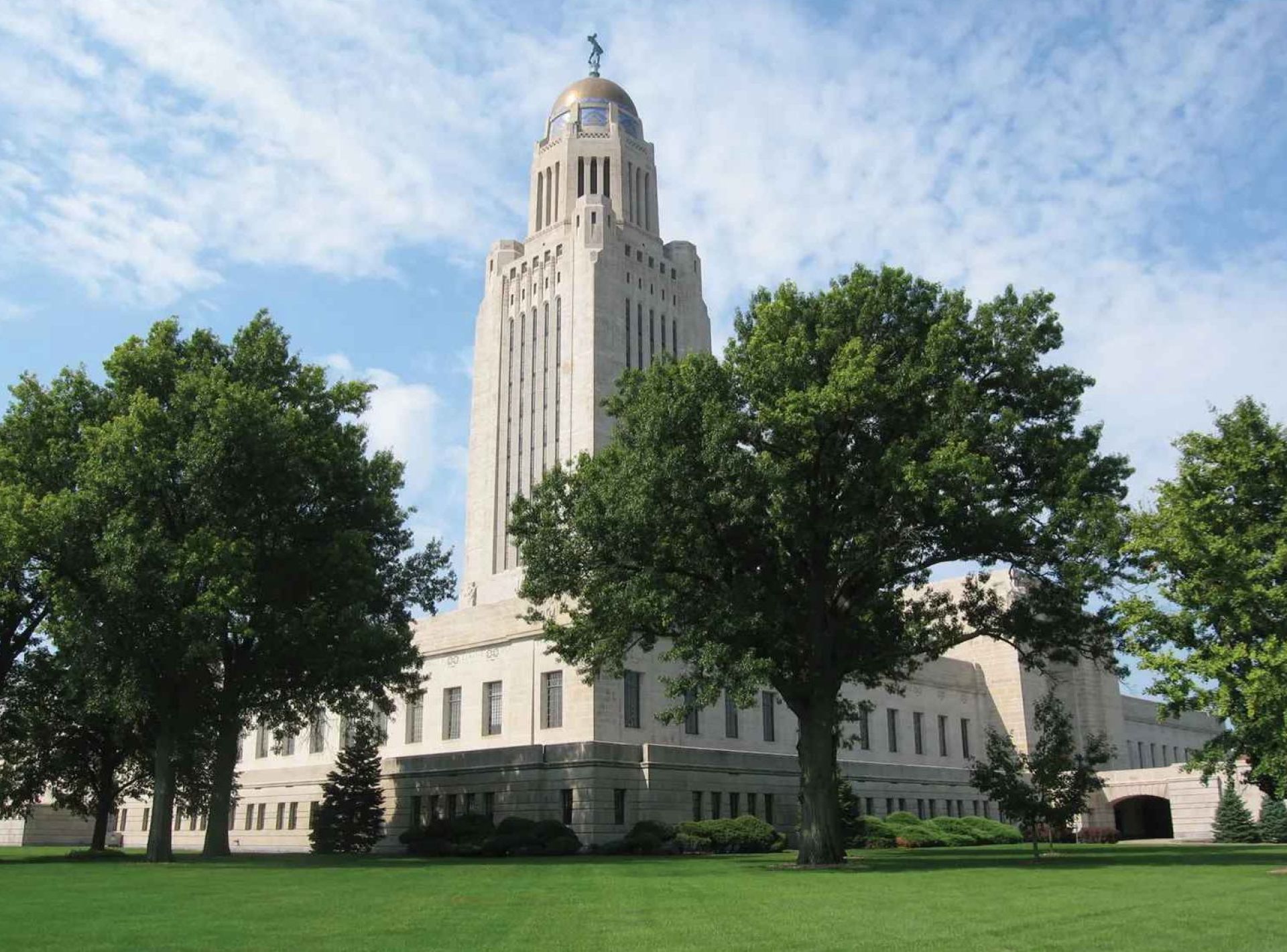 Image of the Nebraska State Capitol building located in Lincoln, showcasing its impressive architecture against a clear blue sky. Image of the Nebraska State Capitol building located in Lincoln, showcasing its impressive architecture against a clear blue sky.