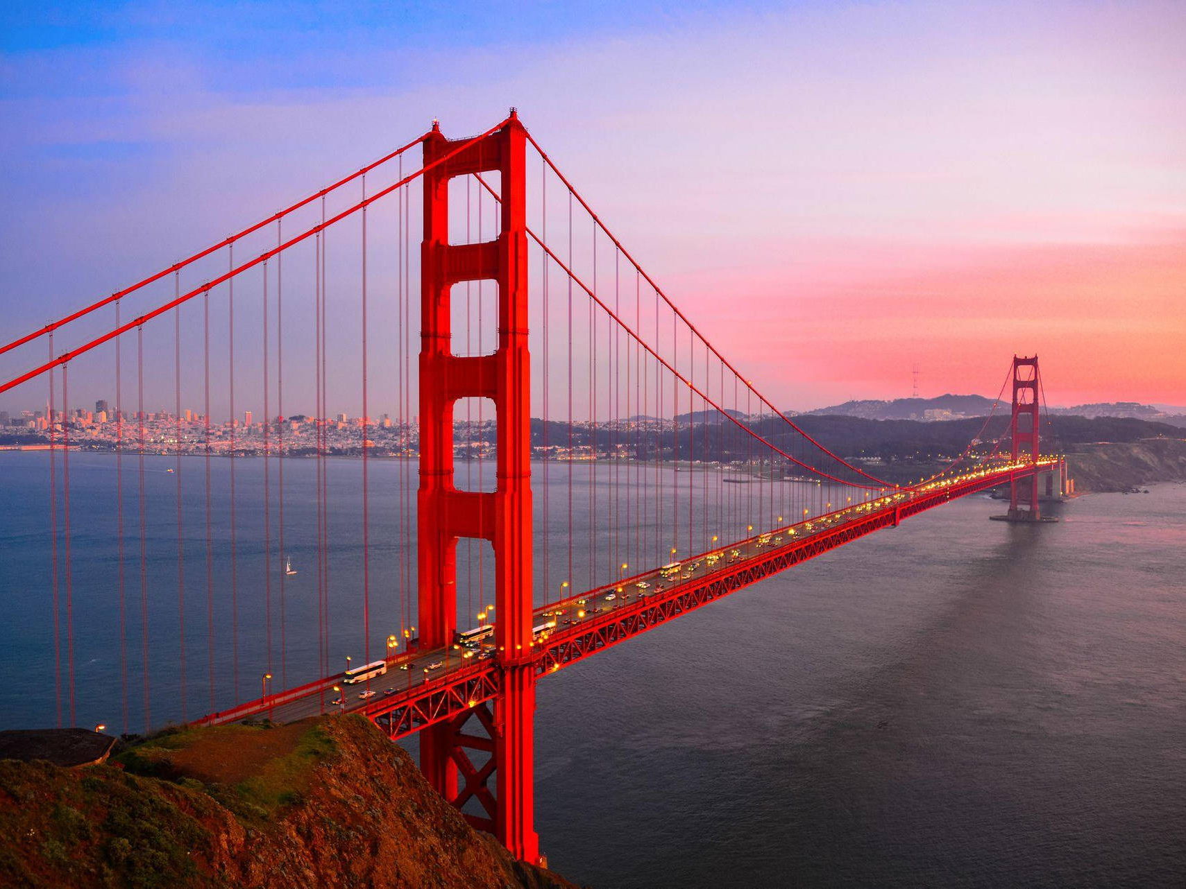 A scenic view of the Golden Gate Bridge in San Francisco, showcasing its iconic orange color against a clear blue sky. A scenic view of the Golden Gate Bridge in San Francisco, showcasing its iconic orange color against a clear blue sky.