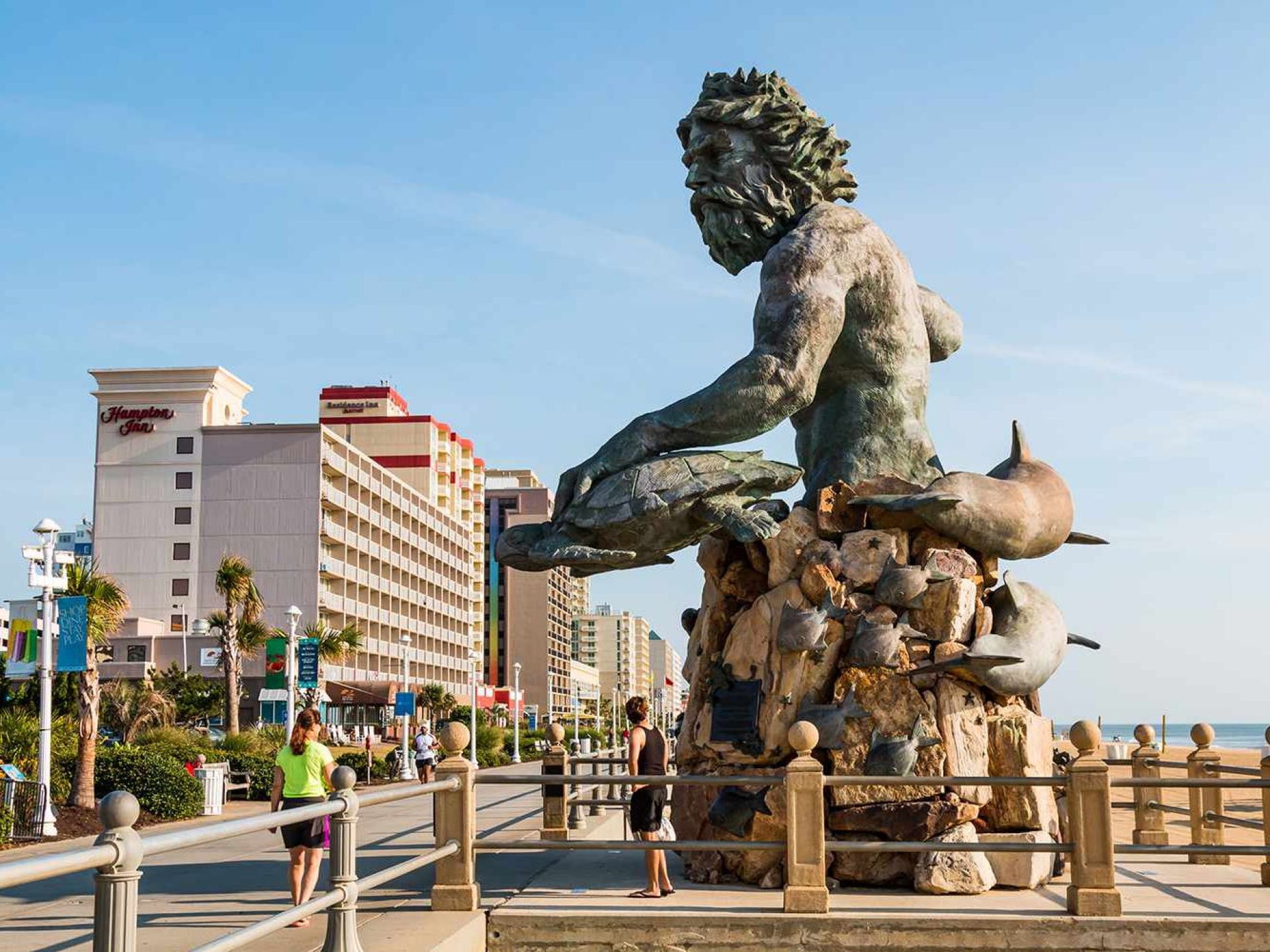 The vibrant Virginia Beach boardwalk bustling with visitors enjoying sunny weather and ocean views. The vibrant Virginia Beach boardwalk bustling with visitors enjoying sunny weather and ocean views.