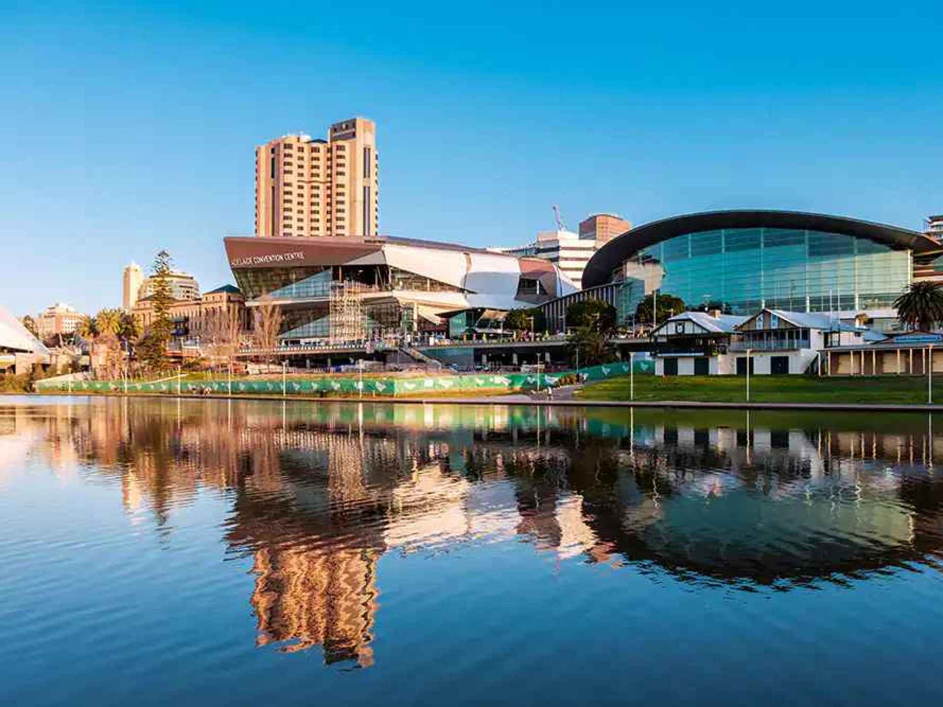 Scenic view of the Torrens River in Adelaide, Australia, showcasing lush greenery and serene waters against the urban backdrop. Scenic view of the Torrens River in Adelaide, Australia, showcasing lush greenery and serene waters against the urban backdrop.