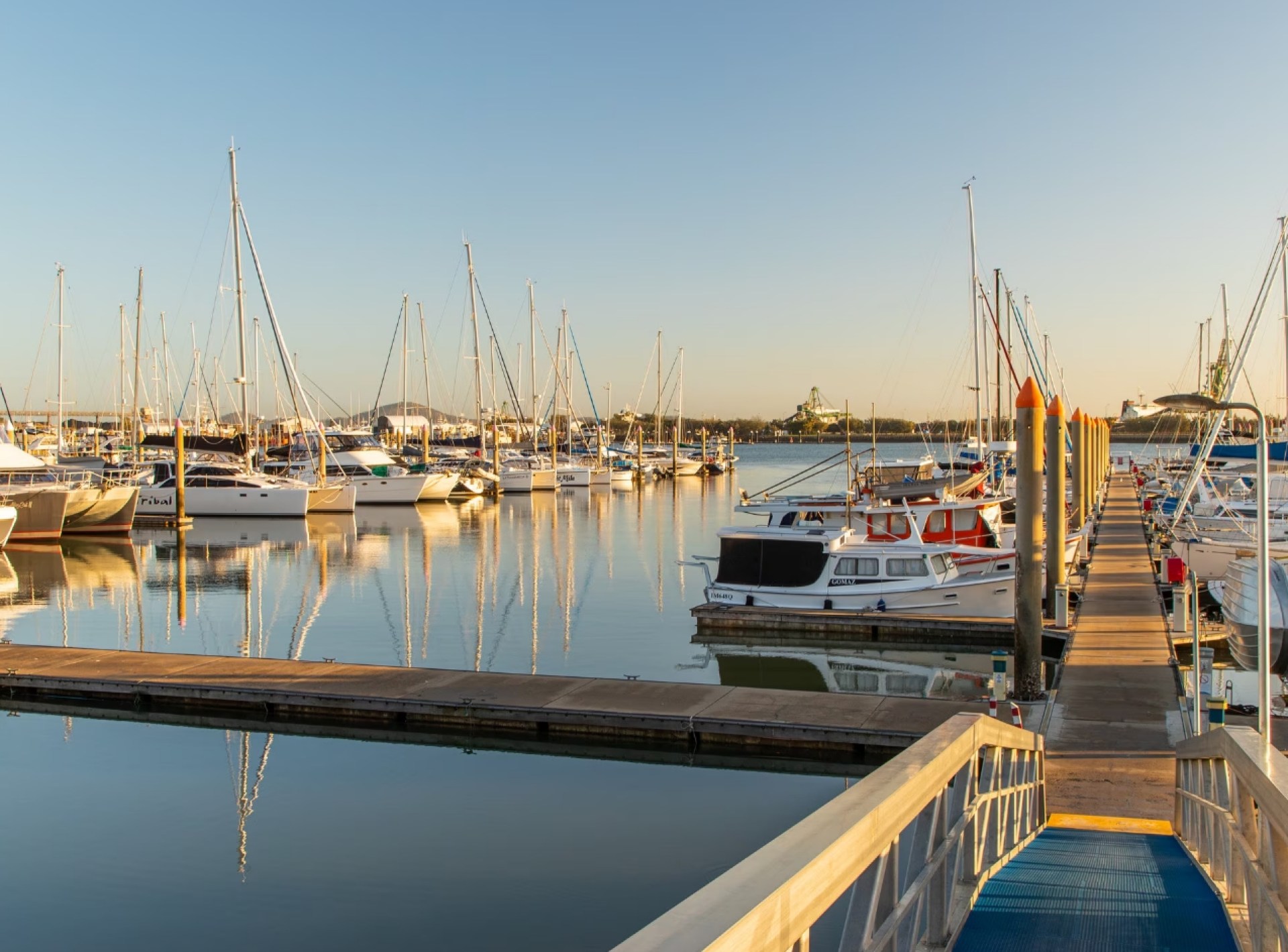 A scenic view of Gladstone Harbour showcasing boats and calm waters under a clear sky, highlighting the beauty of this Australian location. A scenic view of Gladstone Harbour showcasing boats and calm waters under a clear sky, highlighting the beauty of this Australian location.