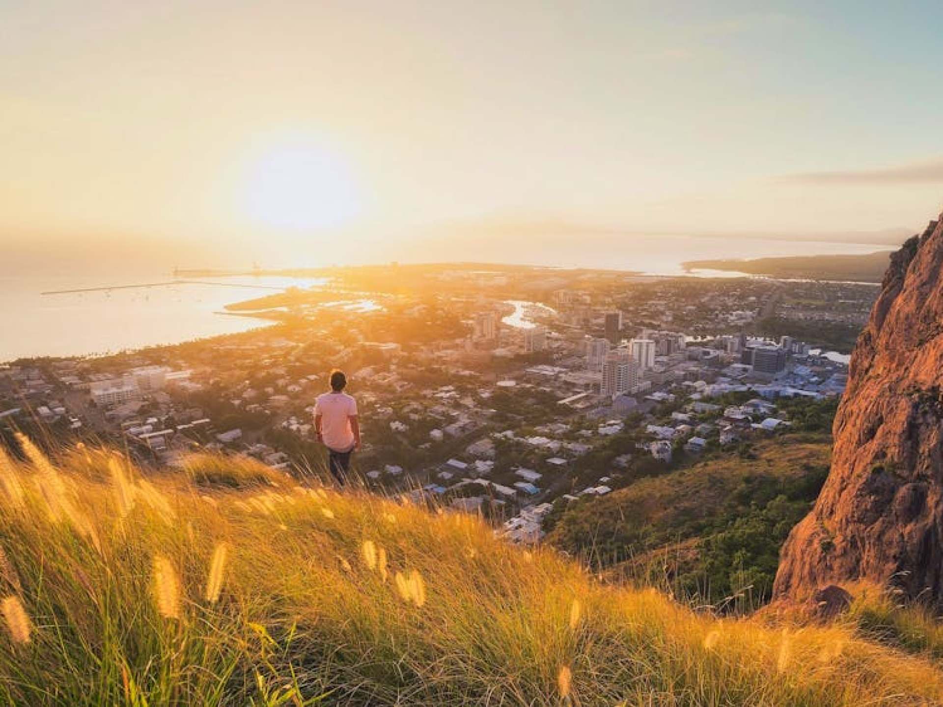 Scenic view of Castle Hill overlooking Townsville, showcasing lush greenery and clear blue skies. Scenic view of Castle Hill overlooking Townsville, showcasing lush greenery and clear blue skies.