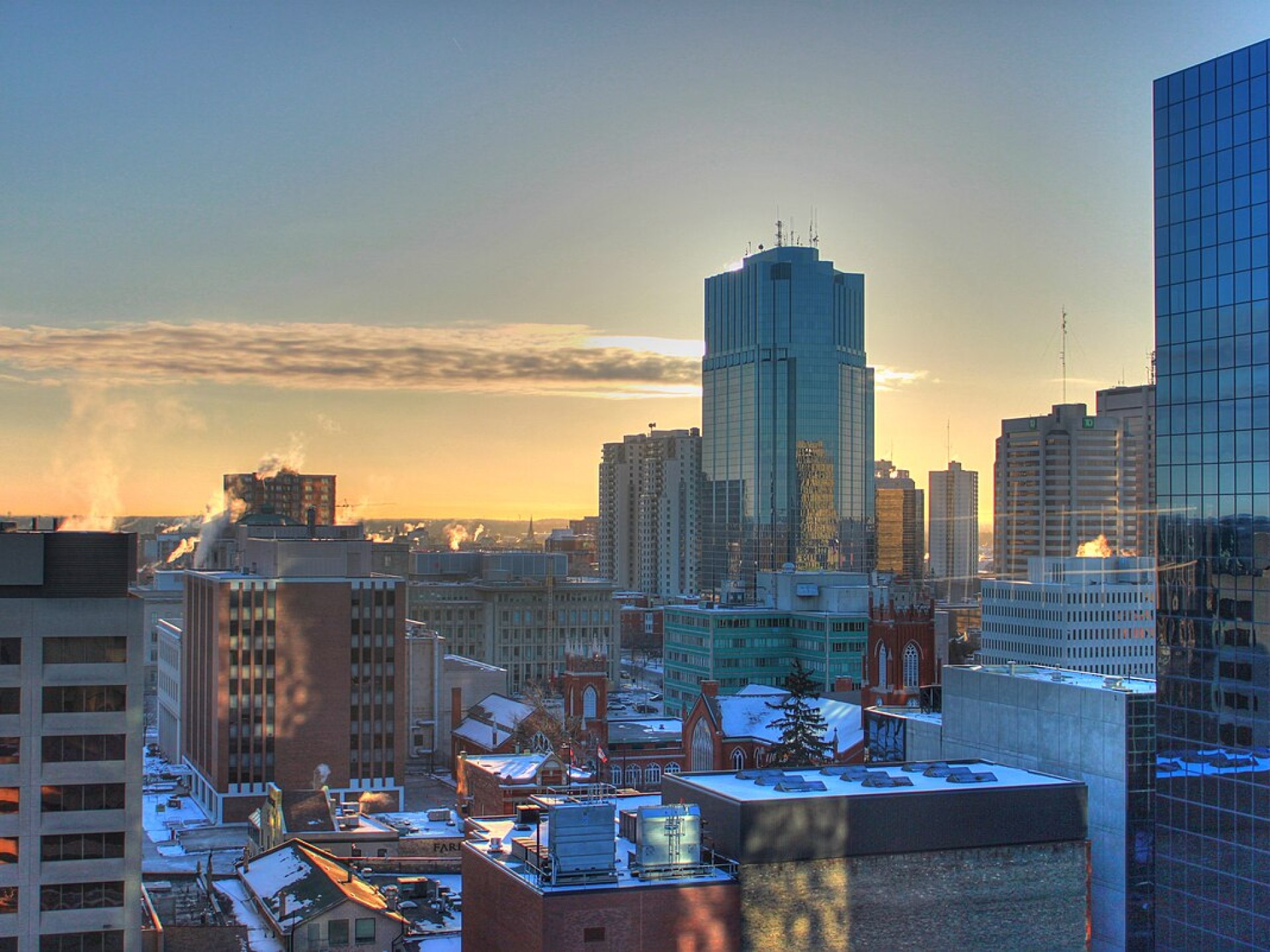 Skyline view of downtown London, Canada showcasing modern buildings against a clear blue sky. Skyline view of downtown London, Canada showcasing modern buildings against a clear blue sky.