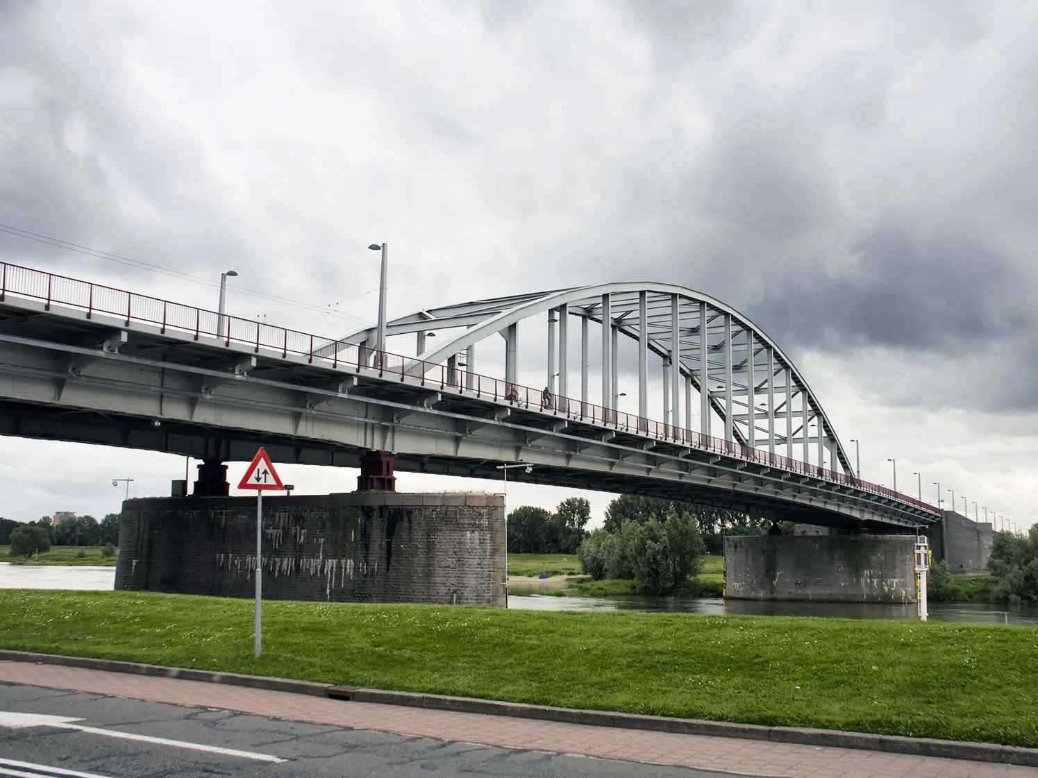 Image of the John Frost Bridge in Arnhem, showcasing its unique architecture against a clear blue sky. Image of the John Frost Bridge in Arnhem, showcasing its unique architecture against a clear blue sky.