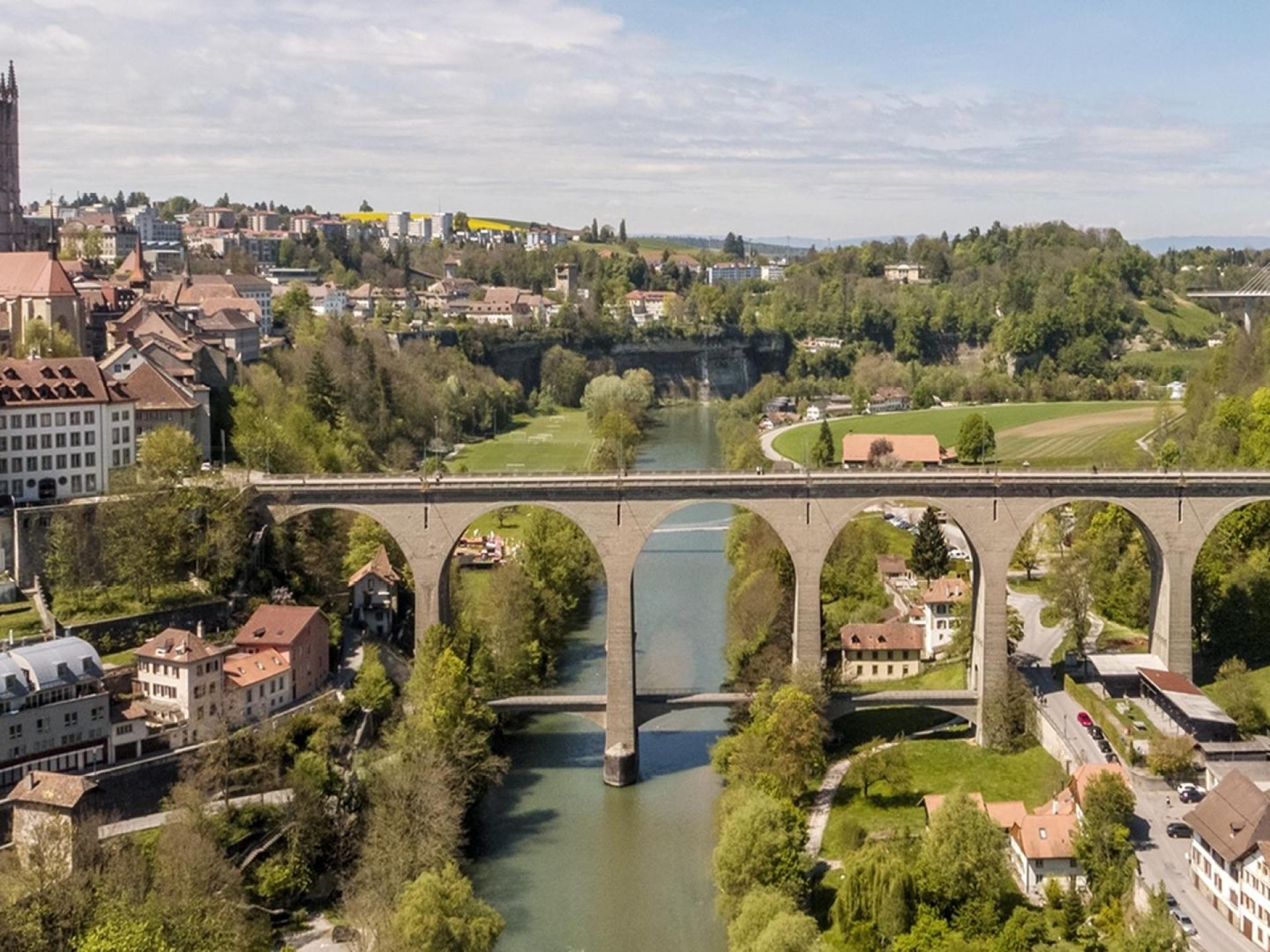 A scenic view of the Zähringer Bridge in Fribourg, Switzerland, showcasing the city's stunning architecture and natural beauty. A scenic view of the Zähringer Bridge in Fribourg, Switzerland, showcasing the city's stunning architecture and natural beauty.