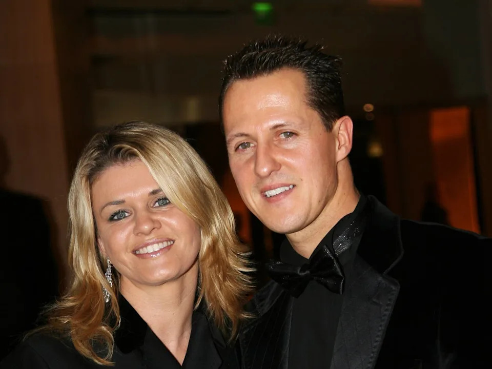 Michael Schumacher indicators F1 race helmet with assist of his spouse Corinna Michael Schumacher indicators F1 race helmet with assist of his spouse Corinna