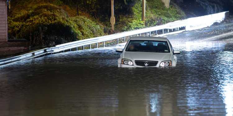 Cyclone Tam: Man forced to climb out of car window to escape floodwaters in Auckland Cyclone Tam: Man forced to climb out of car window to escape floodwaters in Auckland