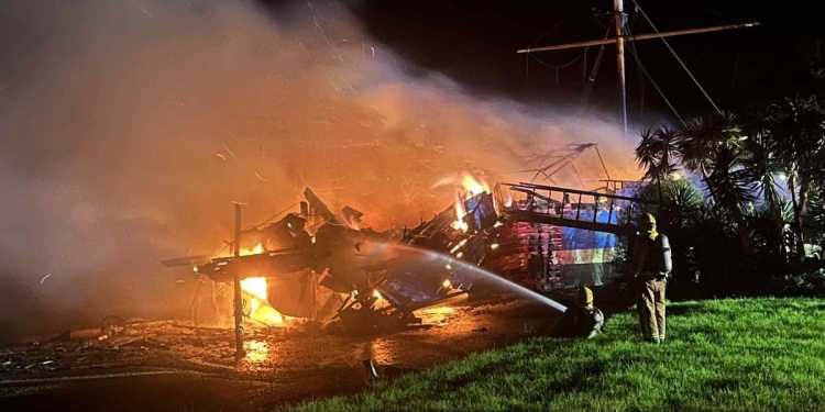 Historic ship The Tui ablaze near Waitangi Bridge in Paihia Historic ship The Tui ablaze near Waitangi Bridge in Paihia