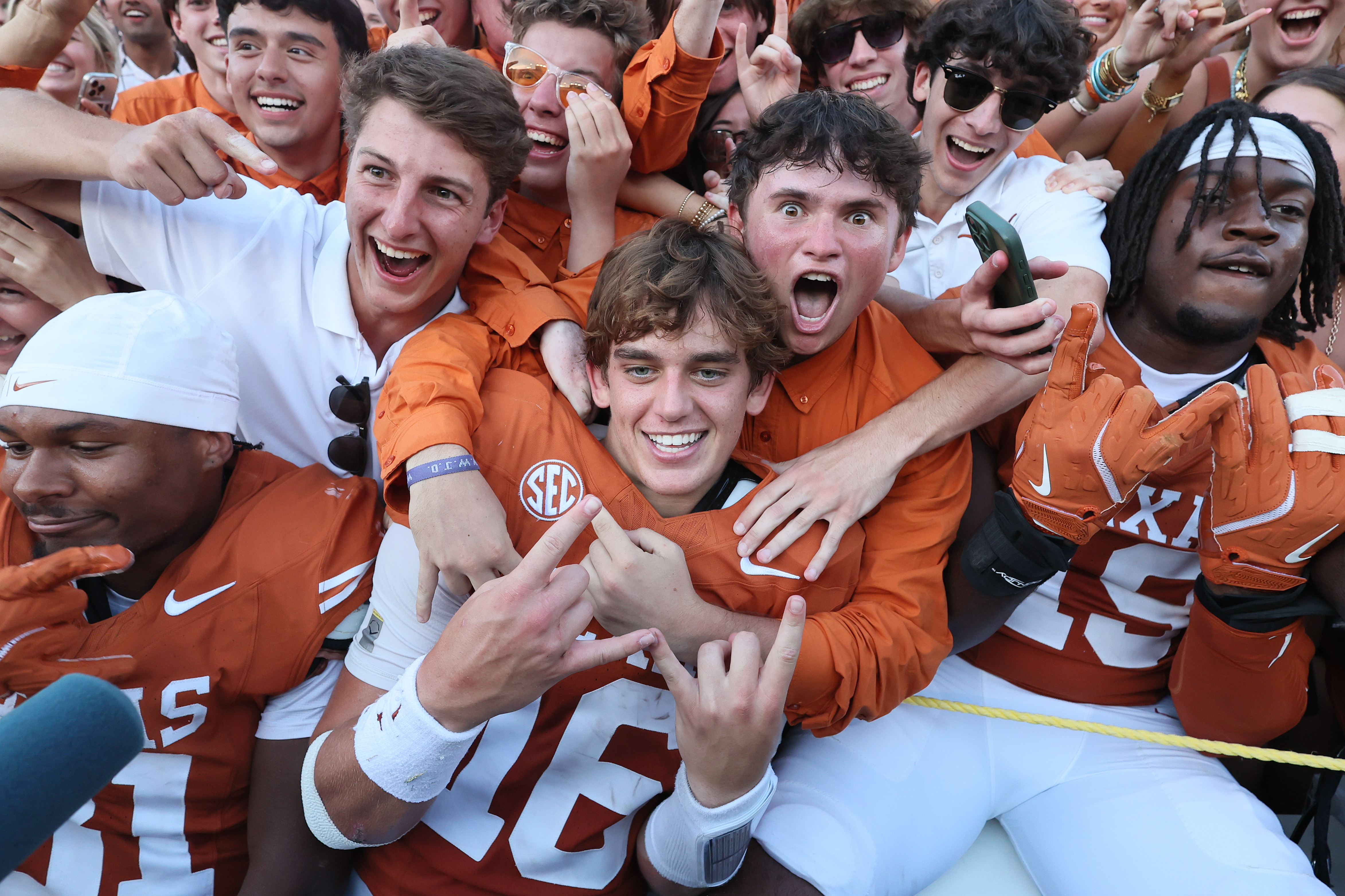 DALLAS, TEXAS - OCTOBER 11: Arch Manning #16 of the Texas Longhorns celebrates with fans after defeating the Oklahoma Sooners at Cotton Bowl Stadium on October 11, 2025 in Dallas, Texas. (Photo by Sam Hodde/Getty Images)