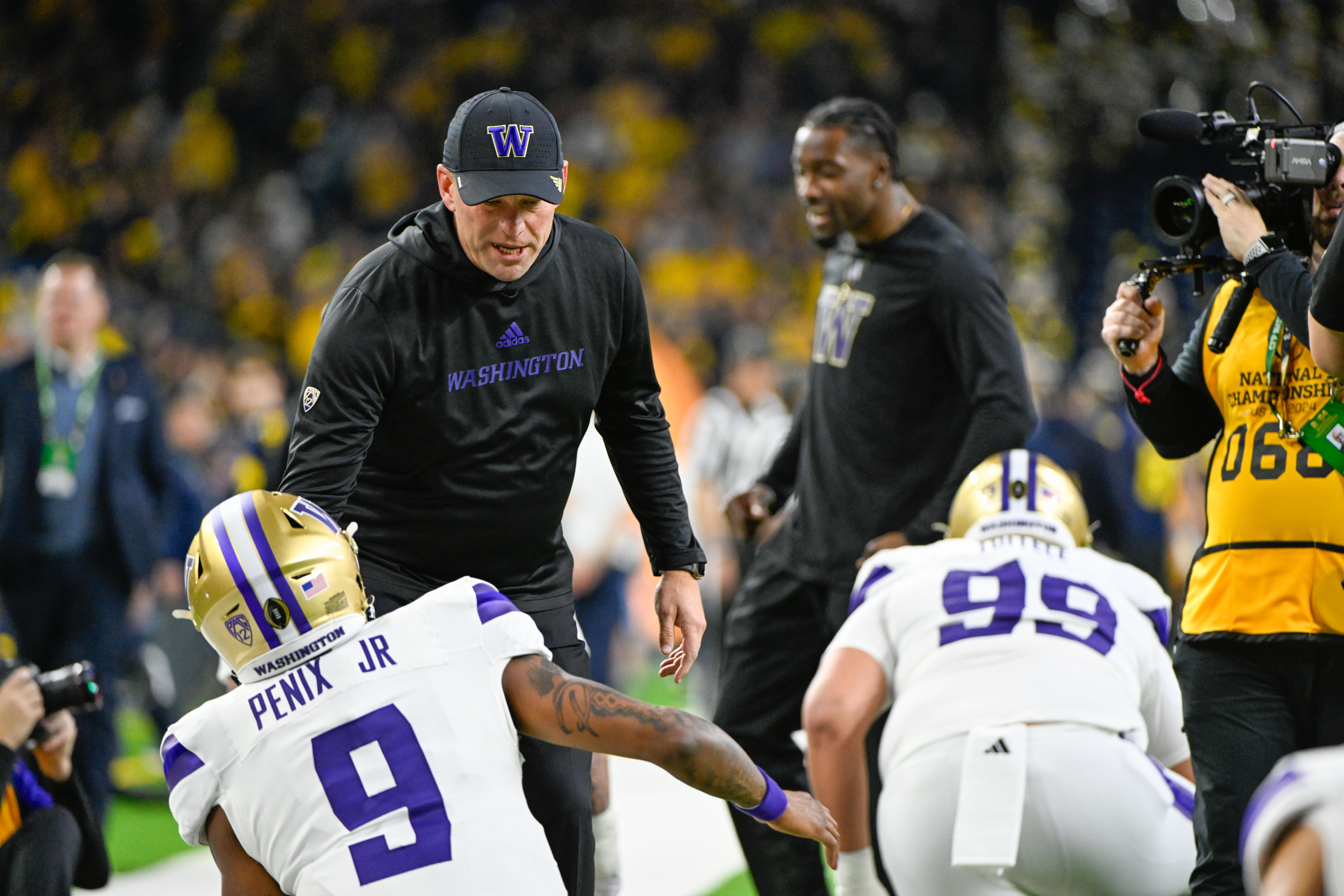 HOUSTON, TX - JANUARY 08: Washington Huskies head coach Kalen DeBoer shakes hands with Washington Huskies quarterback Michael Penix Jr. (9) during warmups during the CFP National Championship football game between the Washington Huskies and Michigan Wolverines at NRG Stadium on January 8, 2024 in Houston, Texas. (Photo by Ken Murray/Icon Sportswire via Getty Images)