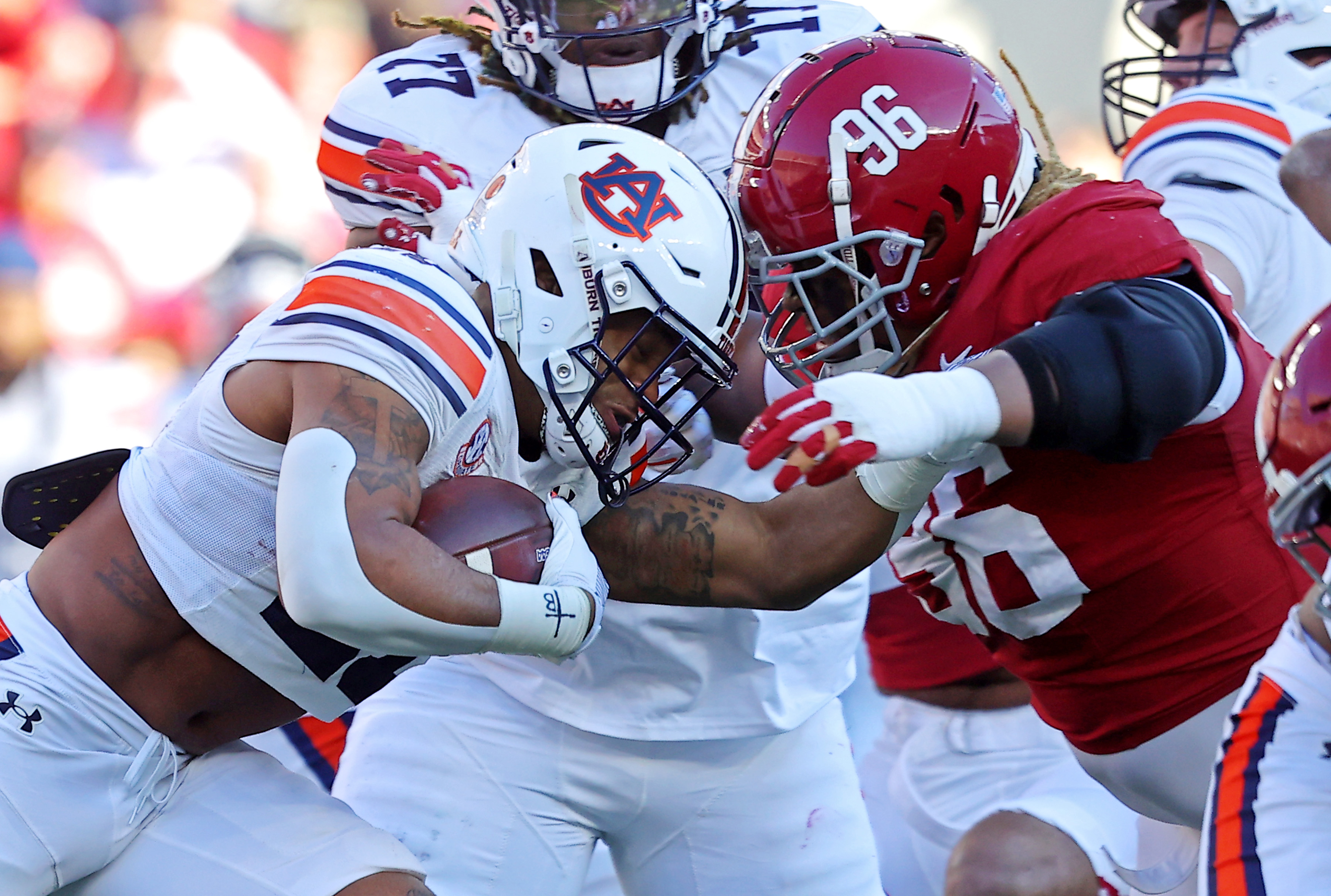 TUSCALOOSA, ALABAMA - NOVEMBER 30: Tim Keenan III #96 of the Alabama Crimson Tide tackles Jarquez Hunter #27 of the Auburn Tigers for no gain during the first half at Bryant-Denny Stadium on November 30, 2024 in Tuscaloosa, Alabama. (Photo by Jason Clark/Getty Images)