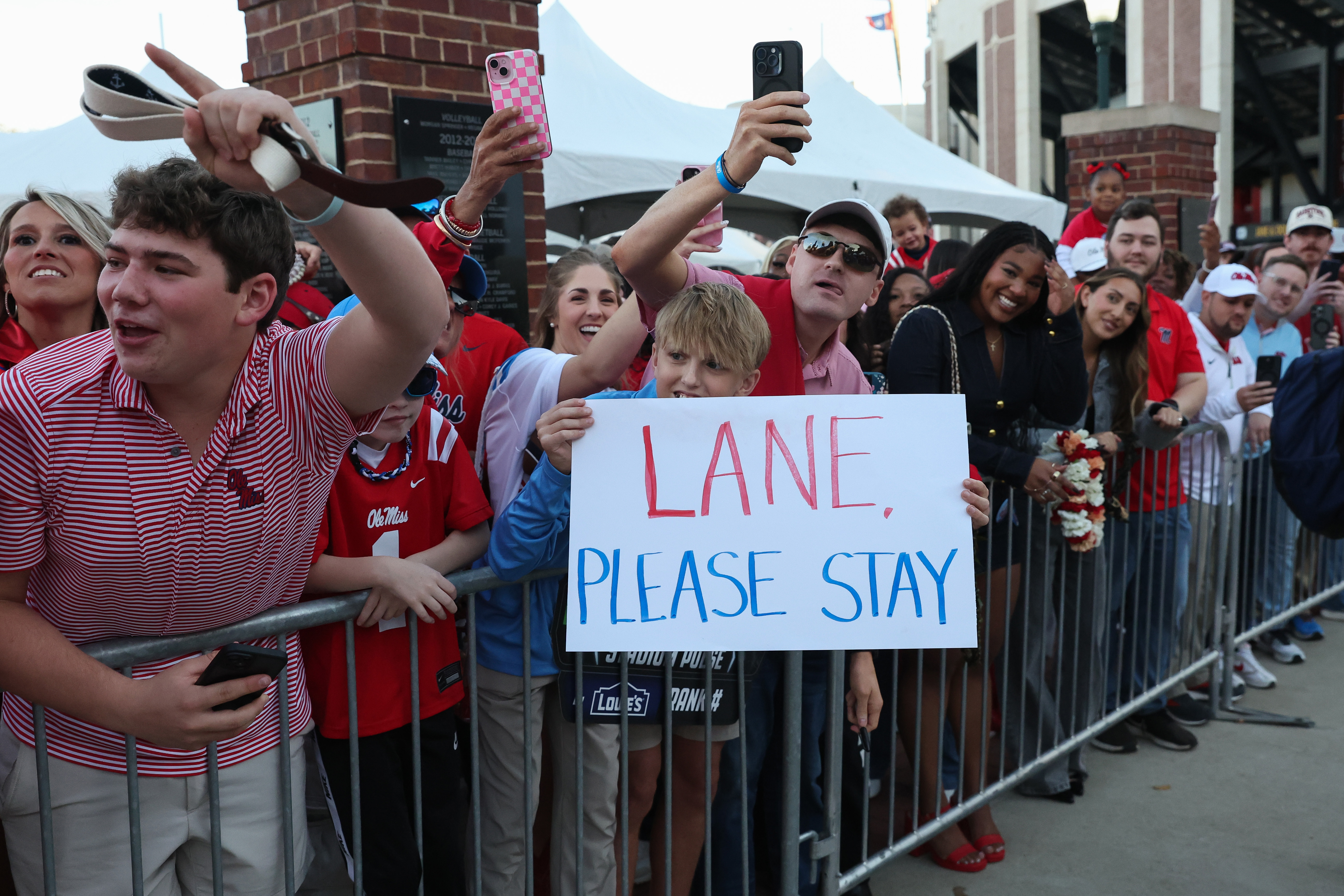 OXFORD, MISSISSIPPI - NOVEMBER 15: Mississippi Rebel fan holds up a sign for Lane Kiffin during the Walk of Champions before the game against the Florida Gators at Vaught-Hemingway Stadium on November 15, 2025 in Oxford, Mississippi. (Photo by Randy J. Williams/Getty Images)