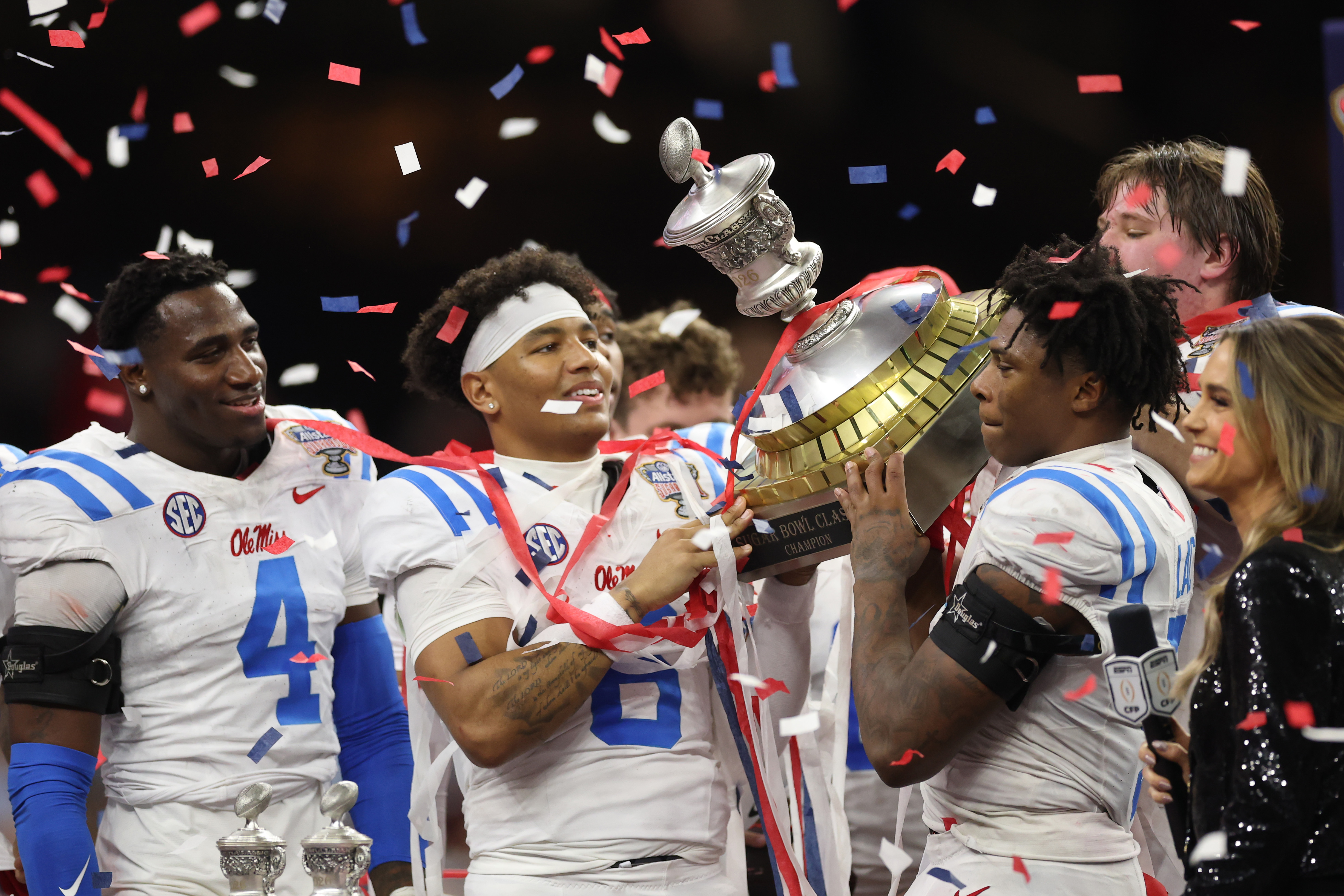NEW ORLEANS, LOUISIANA - JANUARY 01: Trinidad Chambliss #6 and Kewan Lacy #5 of the Ole Miss Rebels hold up the trophy after defeating the Georgia Bulldogs during the 2025 College Football Playoff Quarterfinal at the Allstate Sugar Bowl at Caesars Superdome on January 01, 2026 in New Orleans, Louisiana. (Photo by Jamie Squire/Getty Images)