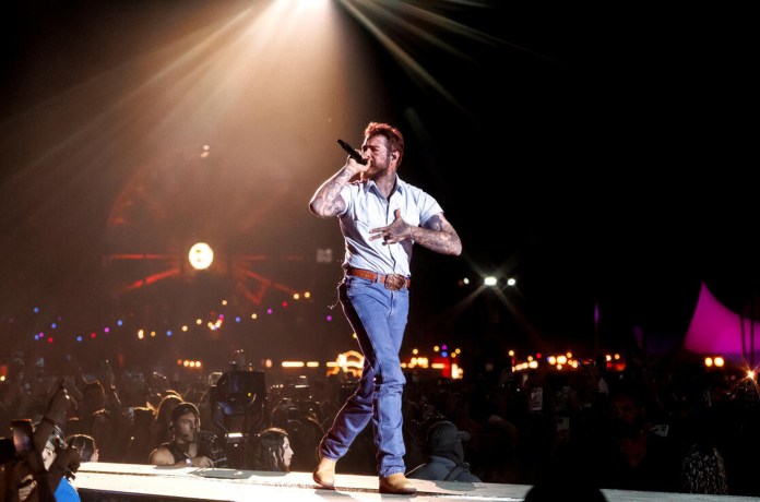 Post Malone Falls Off Stage Mid-Toast During Arizona Show Post Malone Falls Off Stage Mid-Toast During Arizona Show